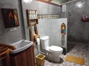 a bathroom with a toilet and a sink at เรือนไทยใจสุขเอ๋ย in Ban Bang Wa
