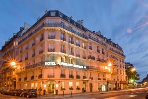 a large building on a city street at night at Pavillon Monceau in Paris