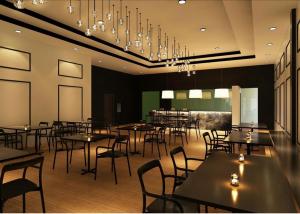 a dining room with tables and chairs and chandeliers at MY Fame Hotel in Seremban