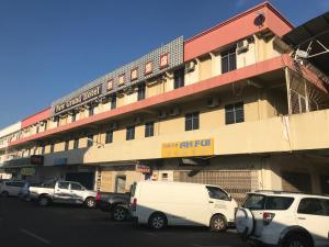 a large building with cars parked in front of it at New Grand Hotel in Keningau