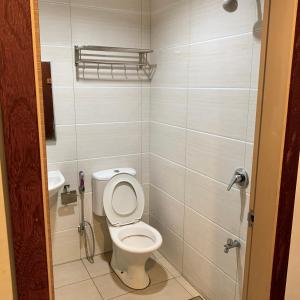 a small bathroom with a toilet and a sink at New Grand Hotel in Keningau +22 photos