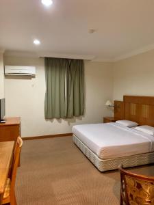Postel nebo postele na pokoji v ubytování New Grand Hotel