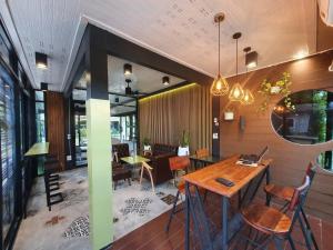 a dining room with a table and chairs in a room at Golden House Hotel Sakaeo in Sa Kaeo