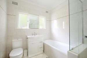 a bathroom with a toilet and a sink and a shower at Scarlett's Place in Blackheath