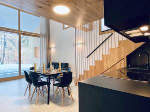 a kitchen and dining room with a table and chairs at Apartments Cokla Zero in Zreče