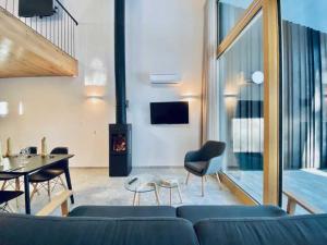 a living room with a blue couch and a fireplace at Apartments Cokla Zero in Zreče