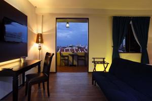 a living room with a couch and a table at Kimberley Hotel Georgetown in George Town