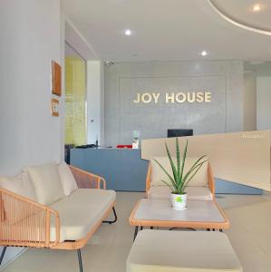 a lobby with a couch and a chair and a table at Joy Hotel Phú Yên in Tuy Hoa