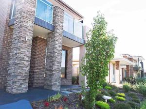 a brick house with a tree in front of it at 4 Bed 2 And A Half Bath Luxury Villa in Point Cook in Point Cook