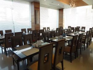 
a restaurant with tables, chairs, and tables in it at Hotel Suba International in Mumbai
