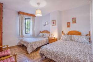 Łóżko lub łóżka w pokoju w obiekcie Casa Rural Monte Dios