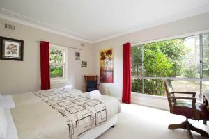 a bedroom with a large bed and a window at The Nineteenth in Blackheath