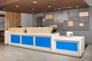a counter in a store with blue glass at Holiday Inn Express Puyallup, an IHG Hotel in Puyallup
