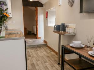 a small kitchen with a table and a counter top at Wren in Scarborough