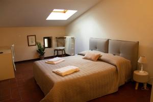 a bedroom with a bed with two towels on it at Borgo delle Mole in Spoleto