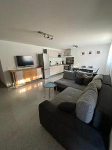 a living room with a couch and a table at Ferienwohnung Müller in Lahr +9 photos
