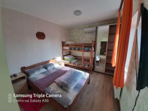 a bedroom with a bed and a bunk bed at Rand in Fontanka