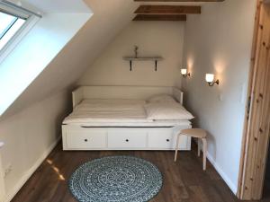 a small bedroom with a bed in the attic at Ferienwohnung in der Uckermark am Oberuckersee OT Warnitz in Warnitz