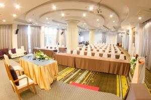 a large room with rows of tables and chairs at Prajaktra Design Hotel in Udon Thani