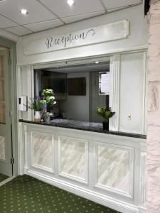 a lobby with a reception counter in a building at Falcon Hotel in Carmarthen