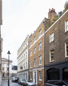 a row of brick buildings on a city street at Bloomsbury By Viridian Apartments in London