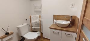 a bathroom with a white toilet and a sink at Apartmán Domčeková in Košice