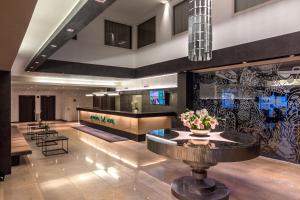 a lobby with a table in the middle of a building at Metropol Hotel in Tallinn