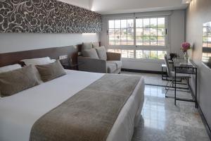 Säng eller sängar i ett rum på Hotel Avenida