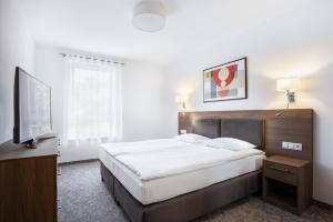 En eller flere senge i et værelse på Bukowy Park Apartamenty