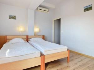 a bedroom with a bed with white sheets at Marynia in Karpacz