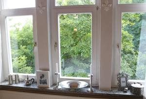 a bathroom with a sink and two windows at Villa Elisenruh in Schmalfeld