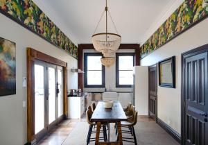 a kitchen and dining room with a table and chairs at The Old Confectionery in Oamaru