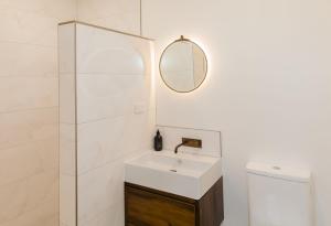 a bathroom with a sink and a mirror at The Old Confectionery in Oamaru +22 photos