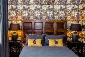 a bedroom with a bed with two lamps on tables at The Old Confectionery in Oamaru