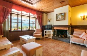 a living room with a fireplace and a tv at Hotel Restaurant Cal Petit in Oliana