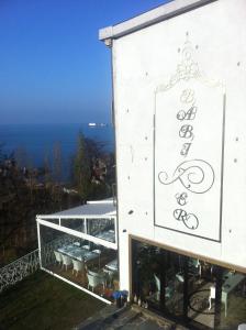 a white building with a sign on the side of it at Bab-i Zer Hotel in Zonguldak