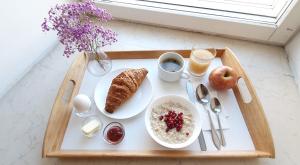 a tray with breakfast foods on a table at LiKi LOFT HOTEL in Saint Petersburg