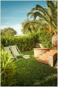 a lawn chair sitting on the grass in a yard at RTA Costa Etrusca in San Vincenzo