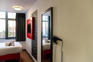 a bathroom with a tub, sink, and shower at easyHotel Newcastle in Newcastle upon Tyne