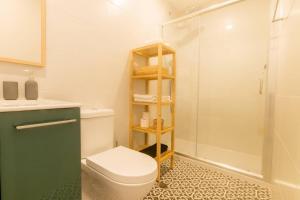 a bathroom with a toilet and a shower at Faro Central - Holiday Apartments in Faro