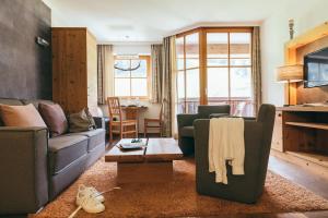 a living room filled with furniture and a window at Boutique Hotel Das Rivus in Leogang