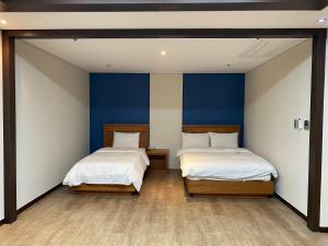 Postelja oz. postelje v sobi nastanitve Benikea Daelim Hotel