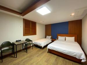 Postelja oz. postelje v sobi nastanitve Benikea Daelim Hotel