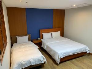 Postelja oz. postelje v sobi nastanitve Benikea Daelim Hotel