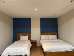Postelja oz. postelje v sobi nastanitve Benikea Daelim Hotel