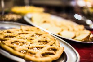 a table topped with three plates of waffle pies at Hotel Zodiaco & Spa in Vaneze