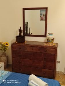 a dresser with a mirror on top of it at Terra del Sole Ribera in Ribera