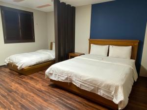 Postelja oz. postelje v sobi nastanitve Benikea Daelim Hotel