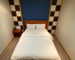 Postelja oz. postelje v sobi nastanitve Benikea Daelim Hotel