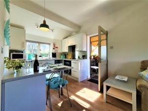 a kitchen and living room with a table and chairs at The Granary in Ruthin